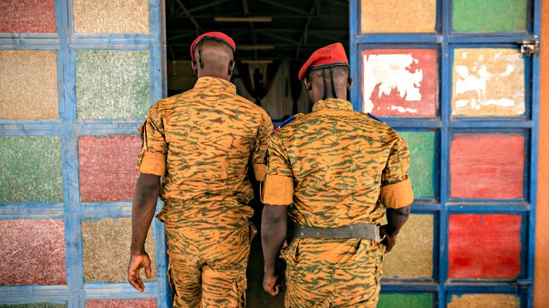Two soldiers enter the Catholic church at the 10th RCAS army barracks in Kaya, Burkina Faso on April 10.