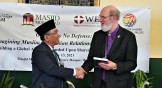 Nahdlatul Ulama leader Yahya Cholil Staquf presents World Evangelical Alliance leader Thomas Schirrmacher with a festschrift at The Nation's Mosque in Washington, DC, during the 2021 International Religious Freedom Summit.