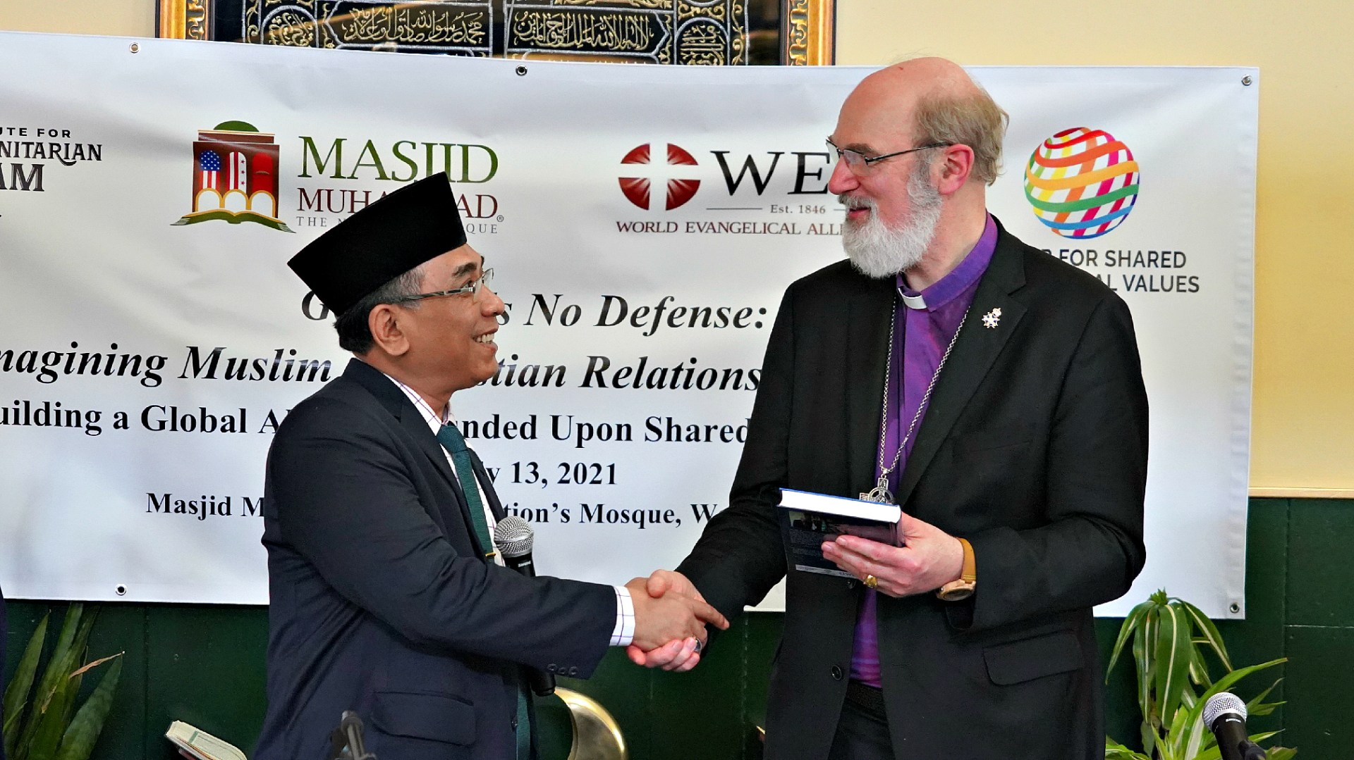 Nahdlatul Ulama leader Yahya Cholil Staquf presents World Evangelical Alliance leader Thomas Schirrmacher with a festschrift at The Nation's Mosque in Washington, DC, during the 2021 International Religious Freedom Summit.