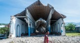A man walks past a church destroyed during an earthquake in Les Anglais, Haiti, on August 14.