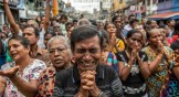 A man cries as he prays in the street near St. Anthony's Shrine one week on from Easter terrorism attacks that killed more than 250 people, on April 28, 2019 in Colombo, Sri Lanka.