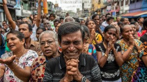 A man cries as he prays in the street near St. Anthony's Shrine one week on from Easter terrorism attacks that killed more than 250 people, on April 28, 2019 in Colombo, Sri Lanka.