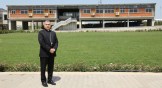 Chaldean Catholic Archbishop Bashar Warda stands in front of the Catholic University of Erbil, located in the Iraqi Kurdistan capital city's Ankawa district.