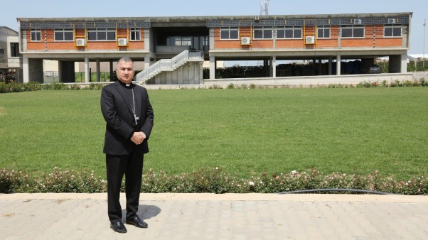 Chaldean Catholic Archbishop Bashar Warda stands in front of the Catholic University of Erbil, located in the Iraqi Kurdistan capital city's Ankawa district.