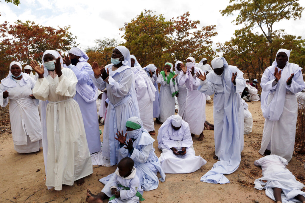 Members of an Apostolic Christian Church group gather for a prayer meeting on the outskirts of the capital Harare on September 10, 2021.