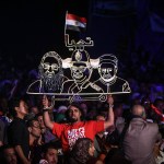 A neon sign portraying now President Abdel Fattah al-Sisi (center) between Coptic Pope Tawadros II (left) and Grand Imam of al-Azhar Shiekh Ahmed el-Tayeb (right) during a rally in Cairo in May 2014.