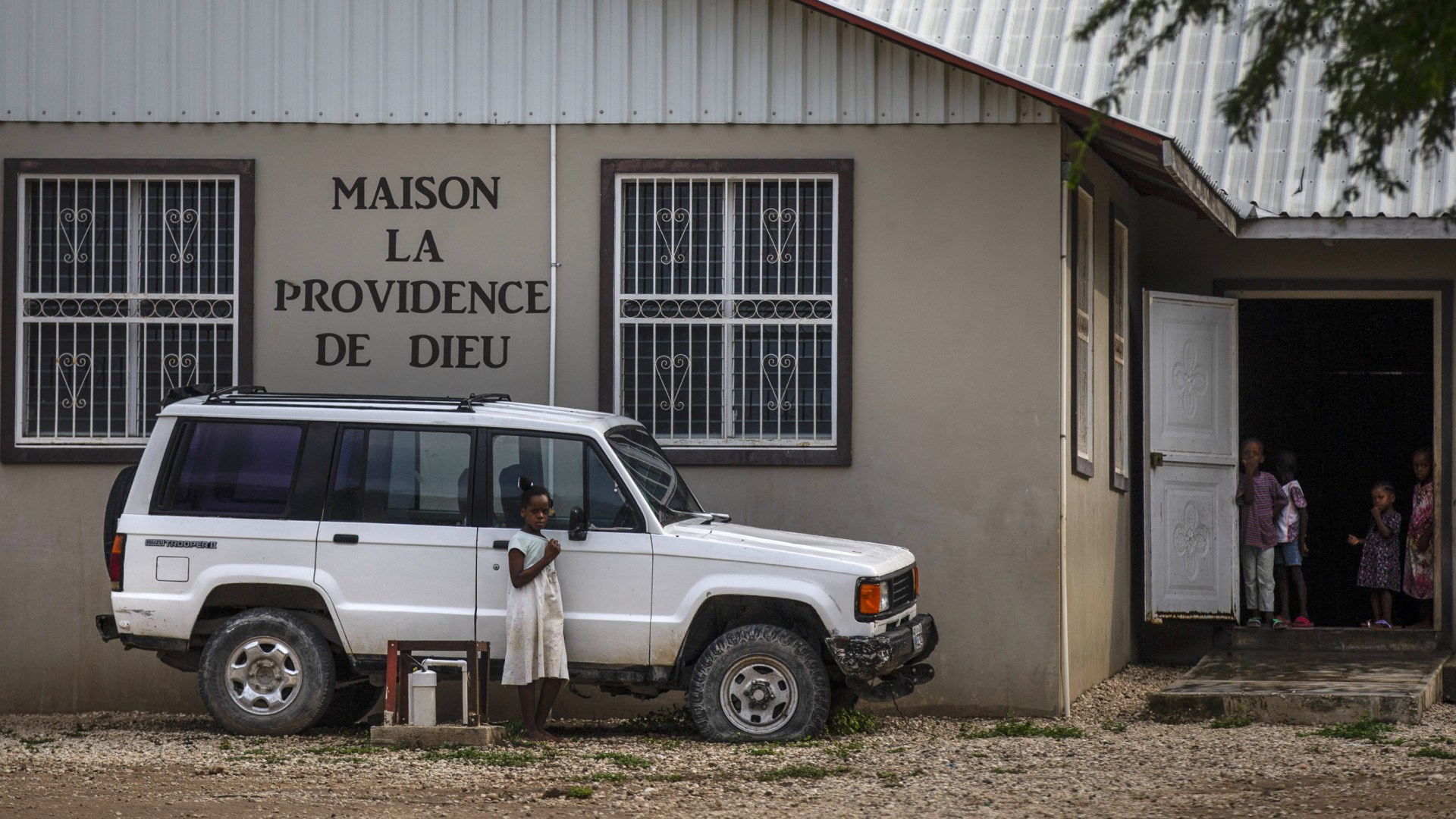Children stand in the courtyard of the Maison La Providence de Dieu orphanage in Ganthier, Croix-des-Bouquets, Haiti on Sunday, October 17, after the 400 Mawozo gang abducted 16 American and one Canadian missionaries from Christian Aid Ministries after a trip to visit the orphanage.