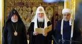 Russian Orthodox Patriarch Kirill I reads a joint statement flanked by Armenian Catholicos Karekin II (left) and Azerbaijan Grand Mufti of the Caucasus Allahshukur Pashazade (right) in Moscow on October 13.
