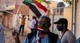 A Sudanese man waves a flag at a Day of Resistance protest on November 13, 2021 in Omdurman, Sudan.