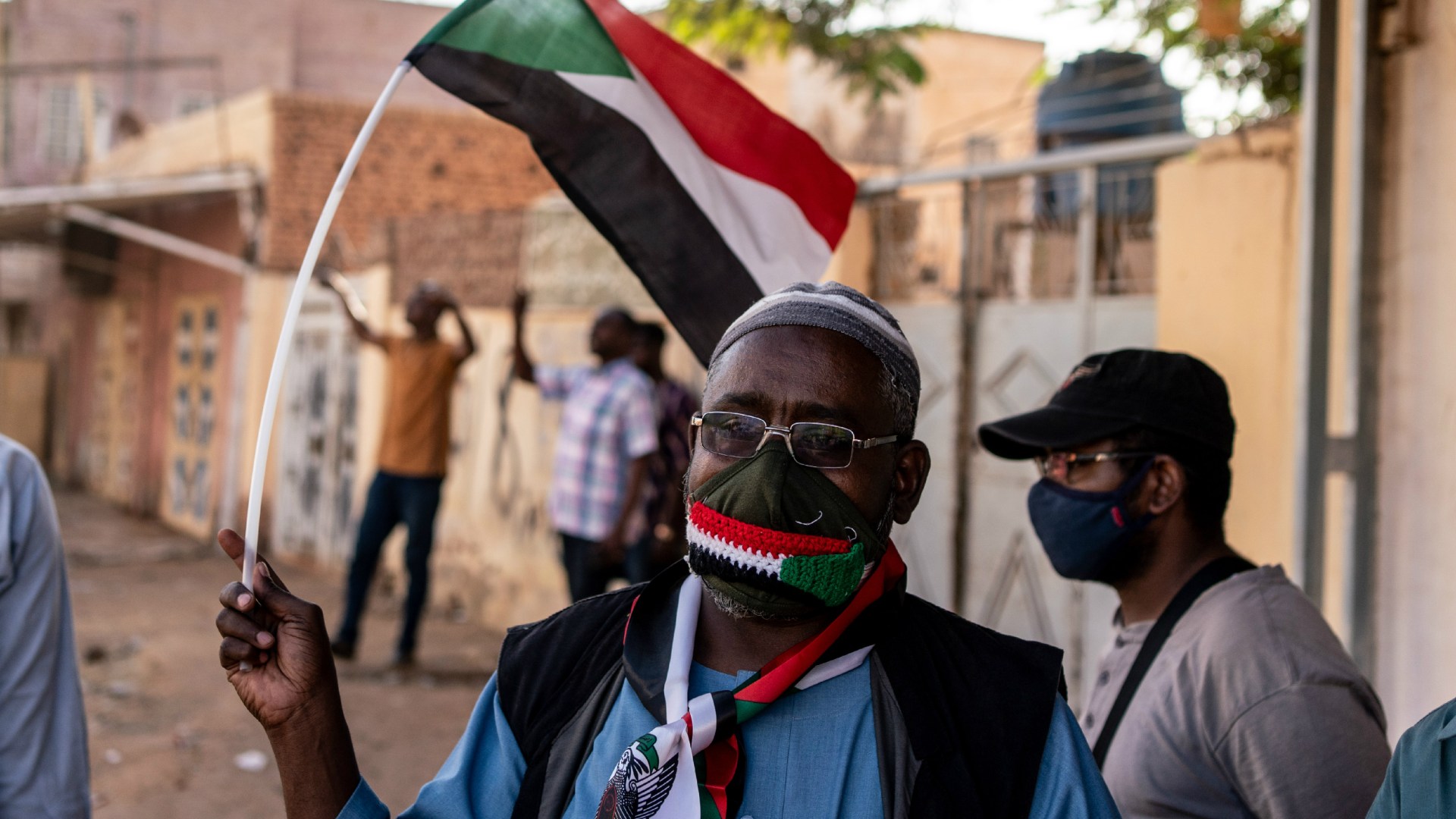 A Sudanese man waves a flag at a Day of Resistance protest on November 13, 2021 in Omdurman, Sudan.