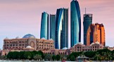 Etihad Towers and Emirates Palace Hotel in Abu Dhabi, UAE.