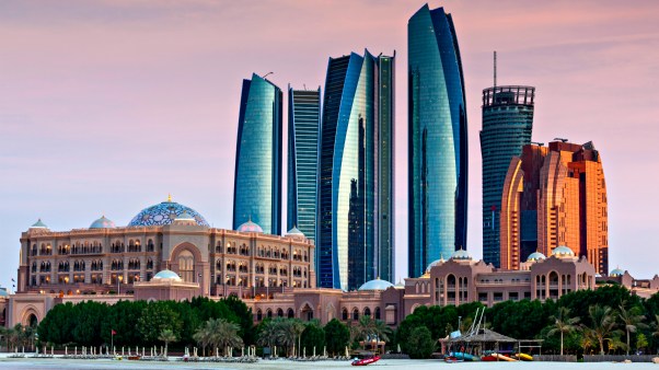 Etihad Towers and Emirates Palace Hotel in Abu Dhabi, UAE.