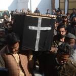 Mourners carry the casket of slain priest William Siraj during a procession on Monday.