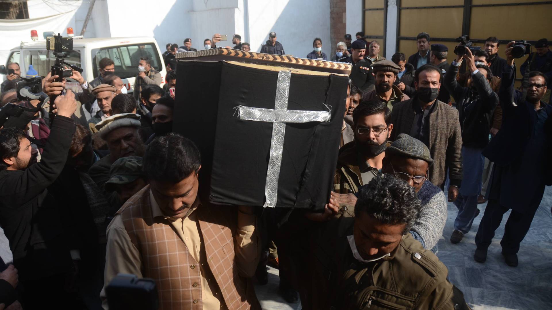 Mourners carry the casket of slain priest William Siraj during a procession on Monday.