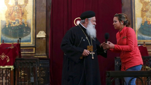 Abouna Makary talks with a visitor, believed to be possessed, during the Coptic Orthodox priest's prayers at St. Mark's Cathedral in Cairo, Egypt.