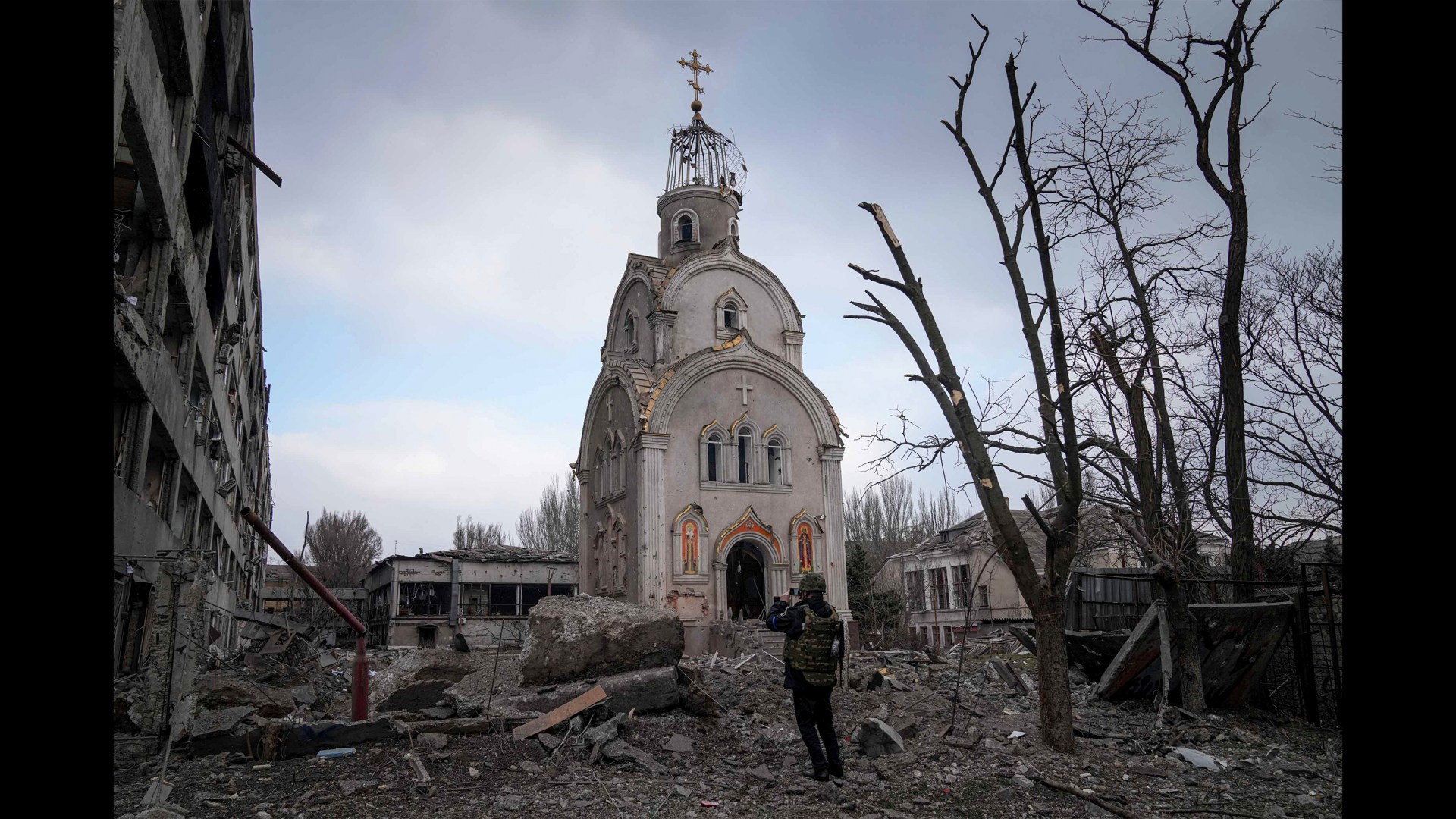 A Ukrainian soldier photographs a damaged church after shelling in a residential district in Mariupol, Ukraine, on March 10.