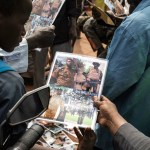 A young boy looks at a poster of lieutenant-colonel Paul-Henri Sandaogo Damiba, new strongman and head of the junta, outside the Grand Mosque of Ouagadougou after Friday prayers on January 28, 2022.