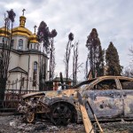 A damaged church and burnt car in Irpin, Ukraine, caused by a Russian military attack on March 9, 2022.