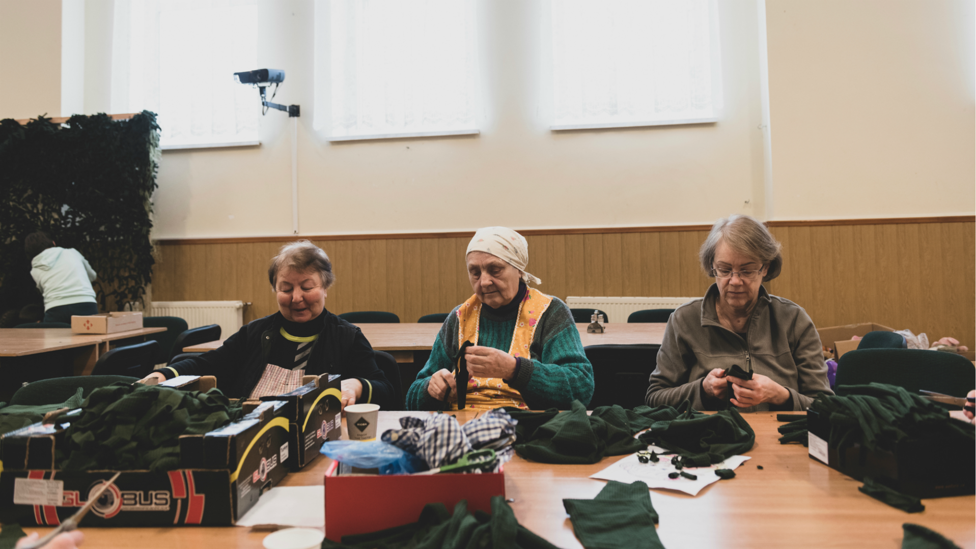Baptist women in Lviv cut up cloth for military camouflage.