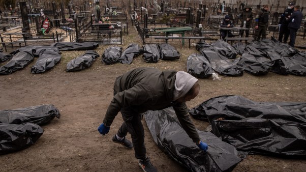 Policemen and forensic personnel catalogue 58 bodies of civilians killed in and around Bucha, Ukraine.