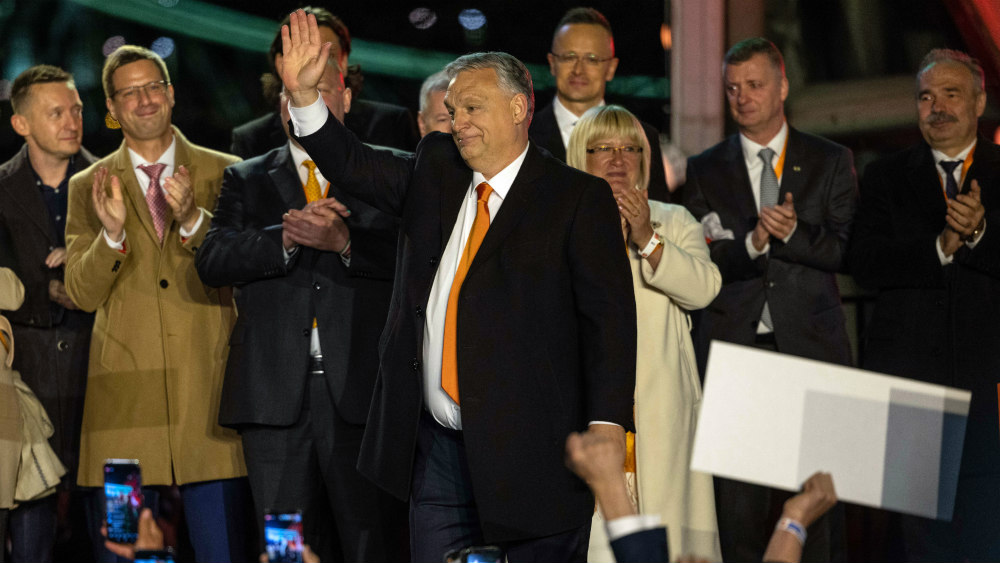 Viktor Orbán waves to supporters as Hungarian election results come in.