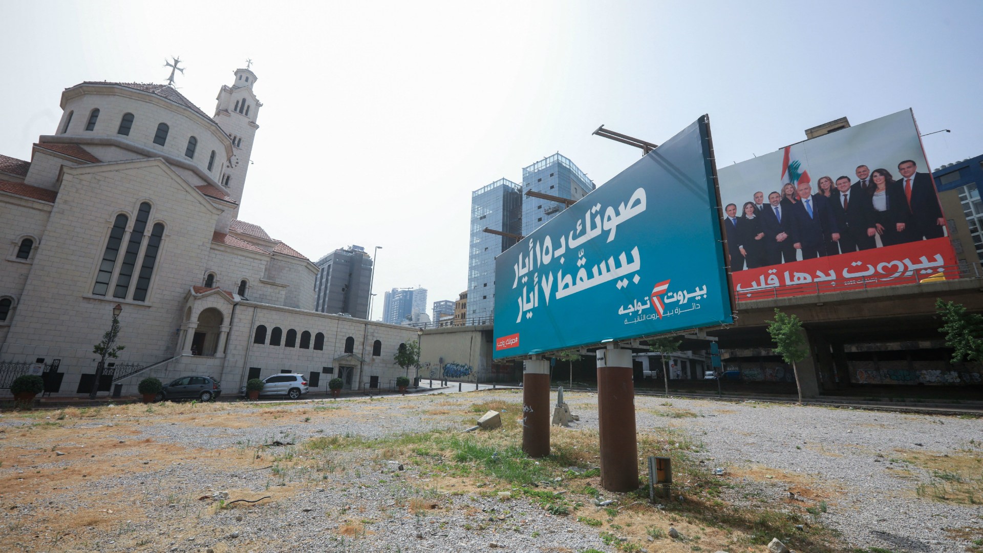 Billboards depicting Lebanese candidate lists and slogans hang near the Armenian Catholic Cathedral of Saint Elias and Saint Gregory in downtown Beirut on May 14, 2022, on the eve of parliamentary elections.