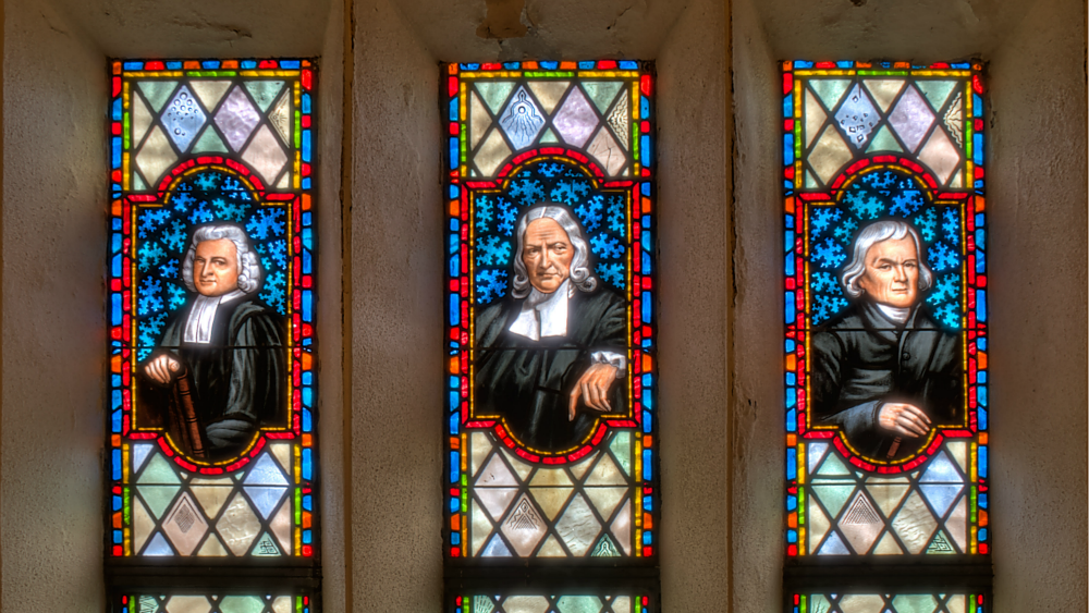 Charles Wesley, John Wesley, and Francis Asbury depicted in stained glass at a church in Lake Junaluska, North Carolina.