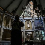 A member of the Cuban Red Cross takes pictures inside Calvary Baptist Church, damaged by an explosion that devastated Havana's Hotel Saratoga in Old Havana, Cuba, on May 6, 2022.