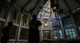 A member of the Cuban Red Cross takes pictures inside Calvary Baptist Church, damaged by an explosion that devastated Havana's Hotel Saratoga in Old Havana, Cuba, on May 6, 2022.