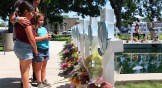 Mourners visit a memorial for a victim's of the mass shooting at an elementary school, in City of Uvalde Town Square.