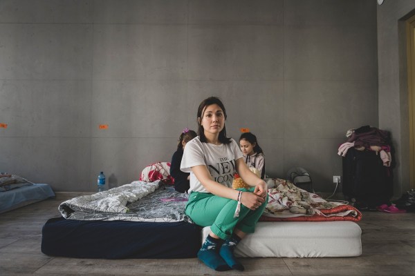 A Ukrainian mother and her children in a shelter at a Pentecostal church in Warsaw.