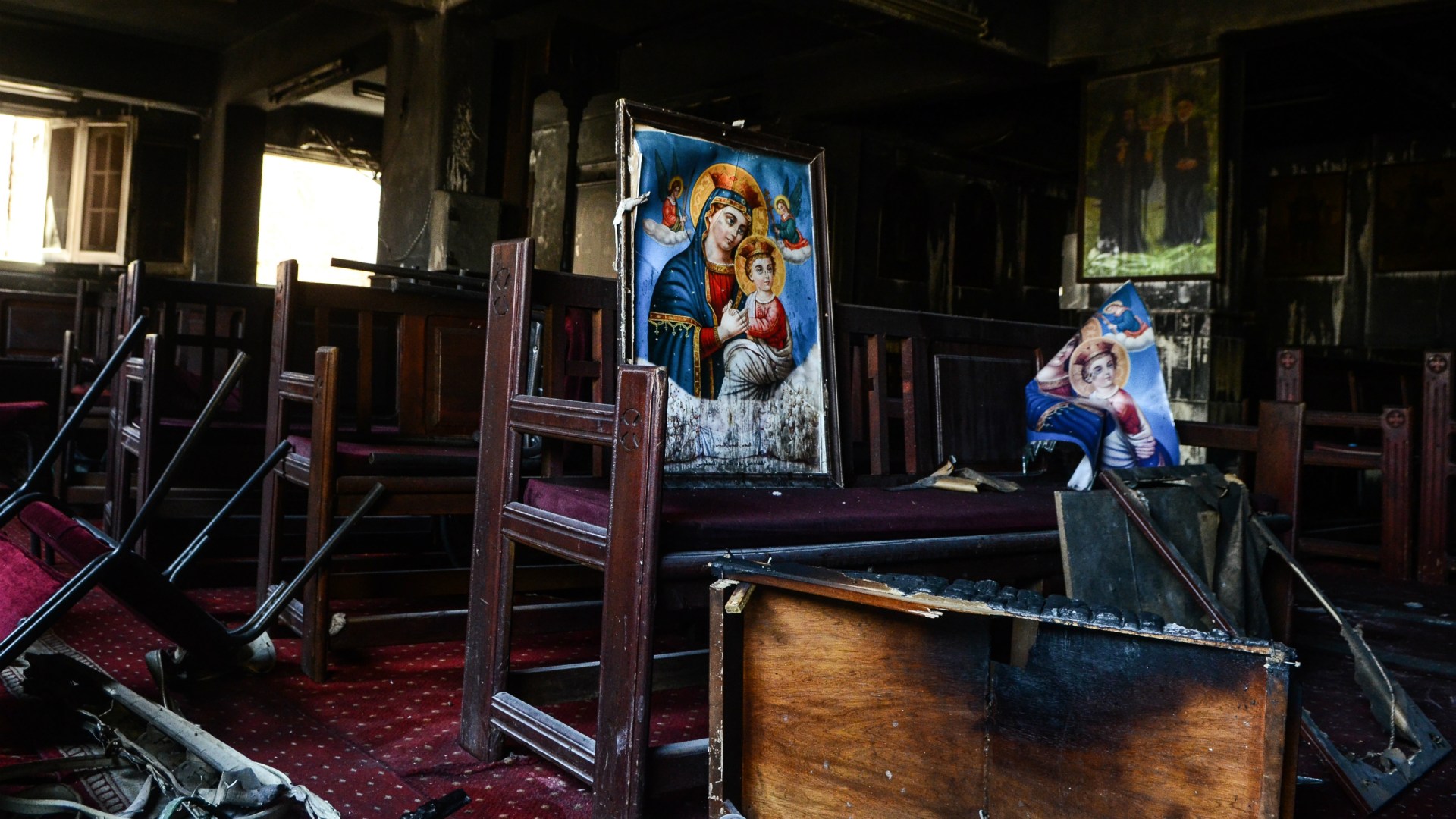 Burnt icons and wooden benches inside Abu Seifein Coptic Orthodox Church in Imbaba after a massive fire broke out during a Sunday service on August 14, 2022.