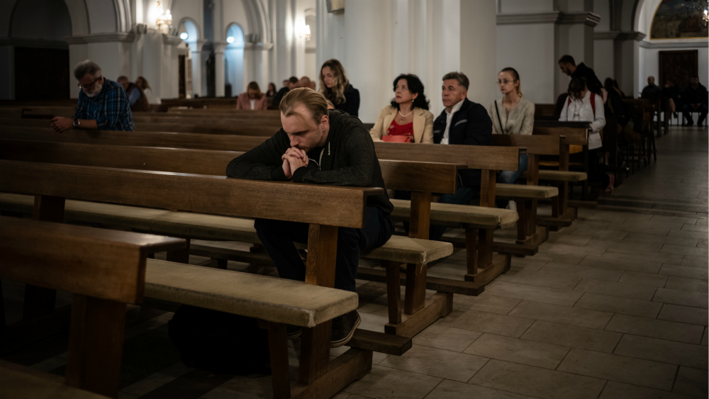 Belarusian protestors pray in a Catholic church during mass anti-government demonstrations.