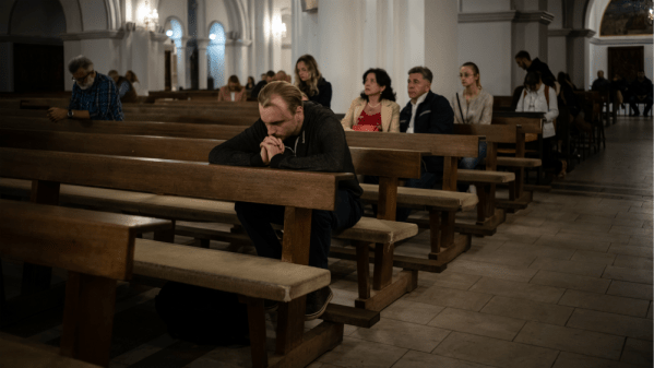 Belarusian protestors pray in a Catholic church during mass anti-government demonstrations.