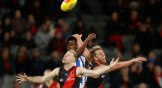 Nick Hind and Dyson Heppell of the Essendon Bombers compete for the ball in an Australian football match with the North Melbourne Kangaroos.