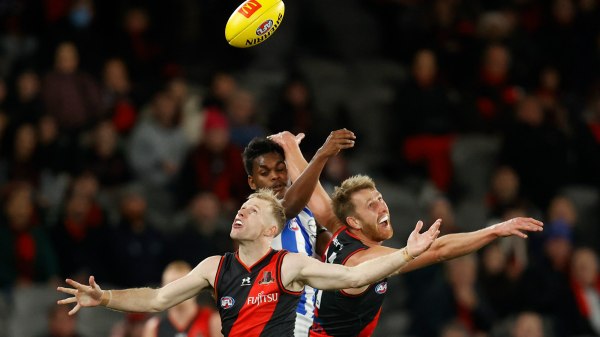 Nick Hind and Dyson Heppell of the Essendon Bombers compete for the ball in an Australian football match with the North Melbourne Kangaroos.