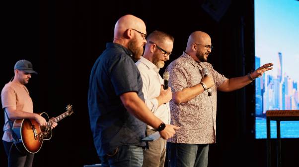 Félix Cabrera (far right), the new vice president of Send Network Español, prays during a regional gathering of church planters and missionary leaders in Miami.