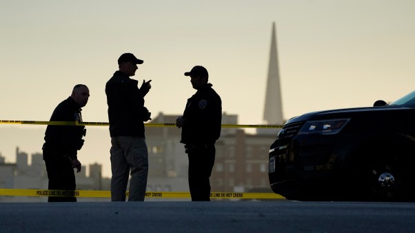 Police stand at the top of the closed street outside the home of House Speaker Nancy Pelosi and her husband Paul Pelosi in San Francisco.