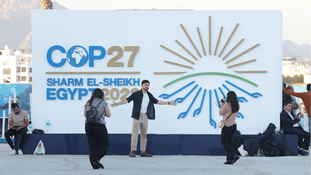 Attendees photograph one another outside the main entrance on the first day of the COP27 climate conference in Sharm El Sheikh, Egypt.
