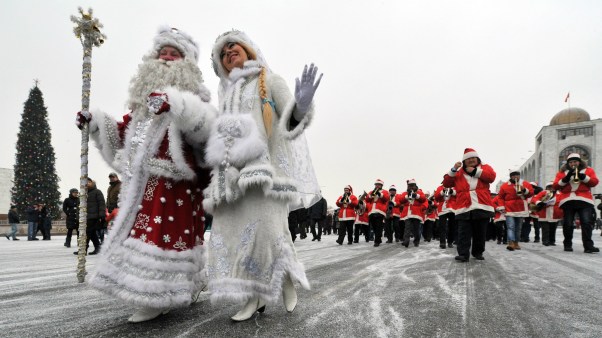 Actors dressed as the Russian Ded Moroz (Grandfather Frost) and his companion Snegurochka (Snow Maiden) take part a New Year parade in Kyrgyzstan's capital Bishkek.