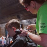 A volunteer cuts hair on one of DUO's outreaches.