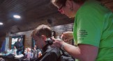 A volunteer cuts hair on one of DUO's outreaches.