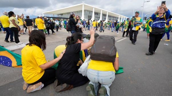 Protesters, supporters of Brazil's former President Jair Bolsonaro, kneel to pray as they storm the Planalto Palace in Brasilia, Brazil.