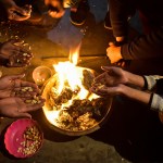 Residents throw sweets, peanuts, puffed rice, and popcorn into a bonfire during the Lohri celebrations in Rajpura.