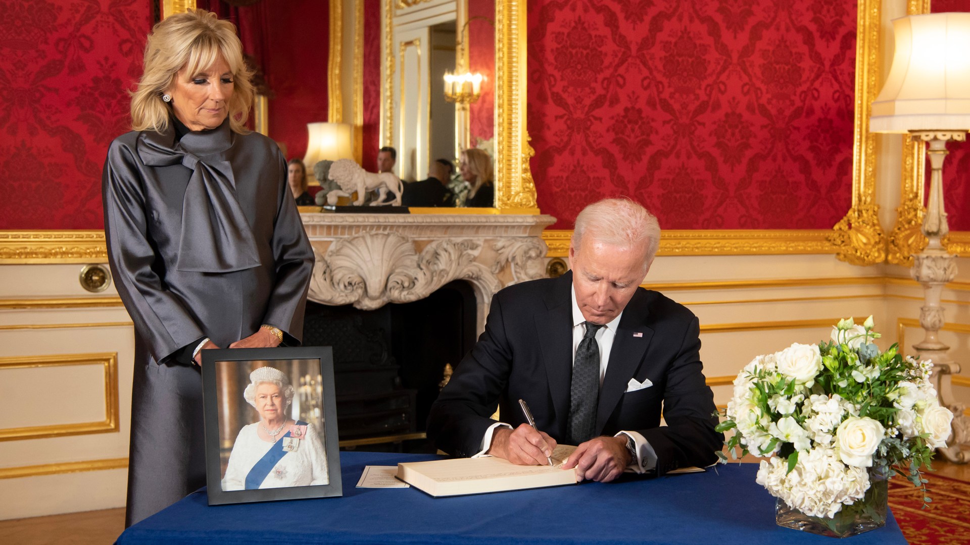 U.S. President Joe Biden, accompanied by the First Lady Jill Biden signs a book of condolence at Lancaster House in London, following the death of Queen Elizabeth.
