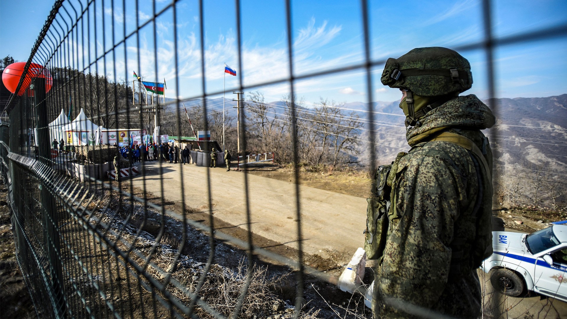 A Russian peacekeeper guards the Lachin corridor as Azerbaijani environmental activists protest against what they claim the illegal mining.
