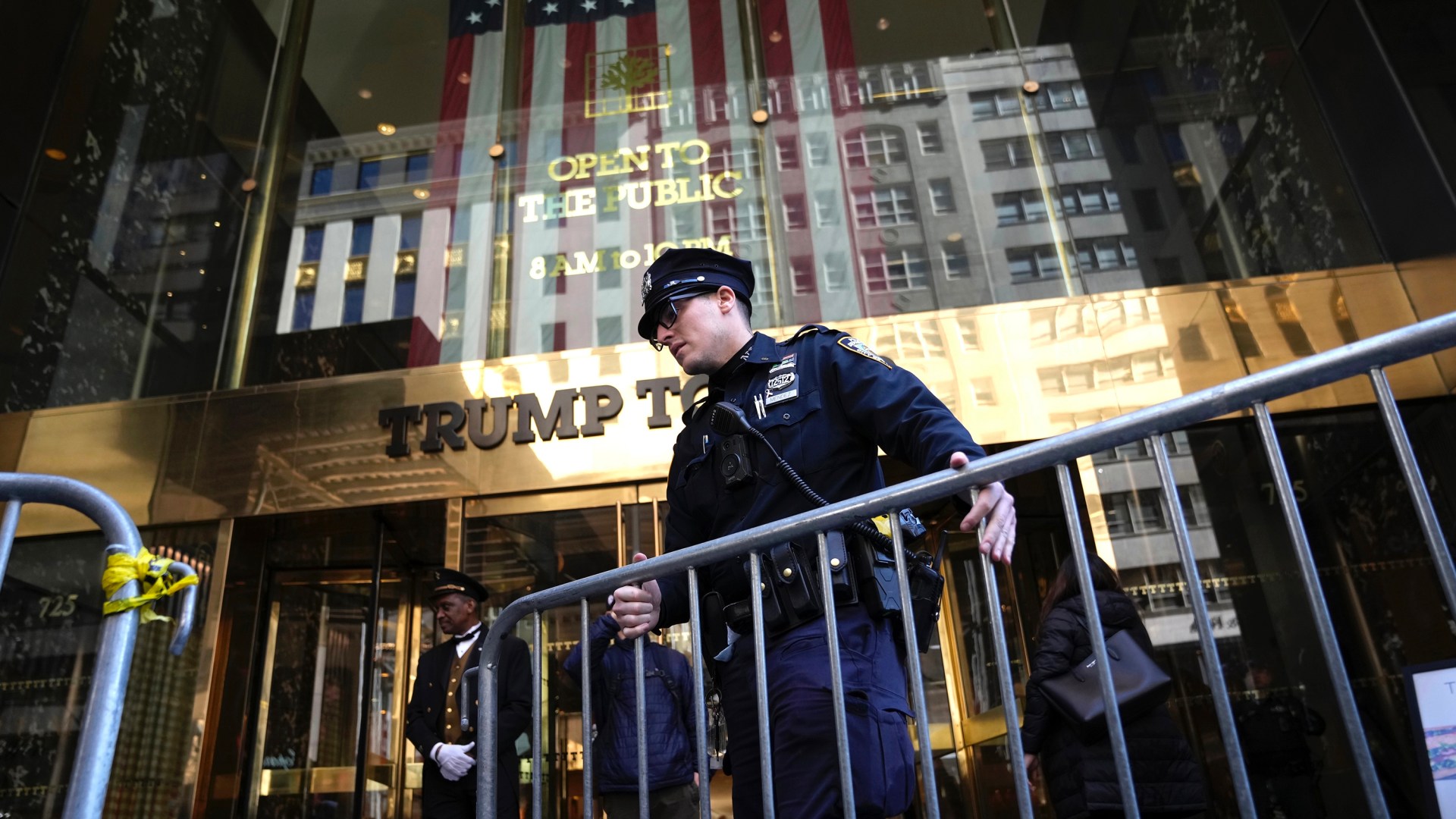 A police officer places a barricade in front of Trump Tower.