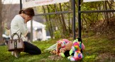 A woman cries as she leaves flowers at the Memorial held at The Covenant School after the shooting in Nashville, Tennessee.
