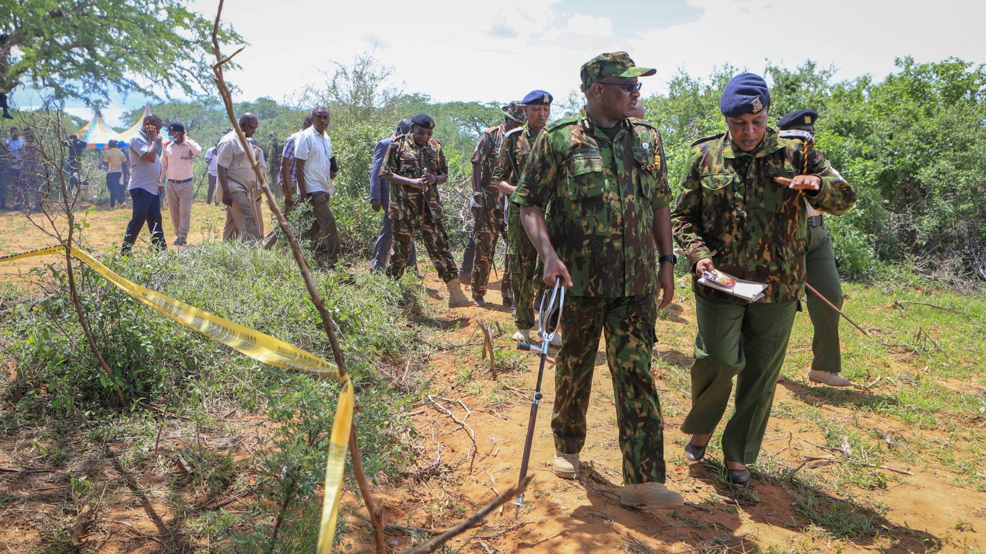 Police search the property near the coastal city of Malindi in southern Kenya where dozens of bodies have been found in shallow graves.