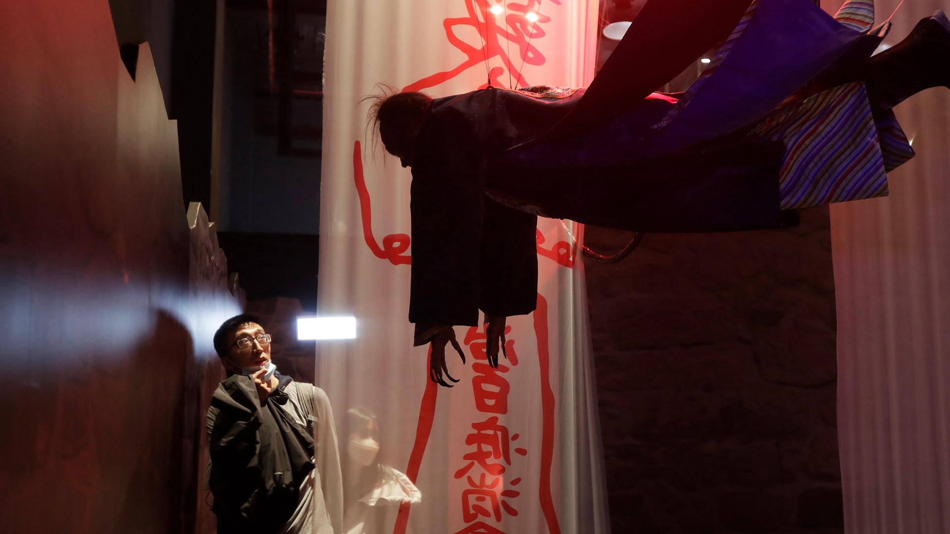 People look at mannequins at a Zombie exhibition in Taipei, Taiwan.